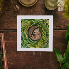 Load image into Gallery viewer, Art print of a squirrel on leaves on a wooden surface with plants and books.
